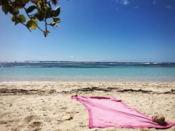 Scenic view of beach against clear blue sky