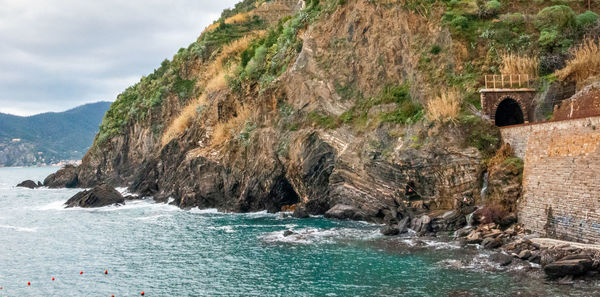 Scenic view of sea and mountains against sky