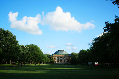 Trees in park with building in background