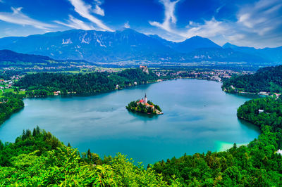 High angle view of plants and mountains against blue sky