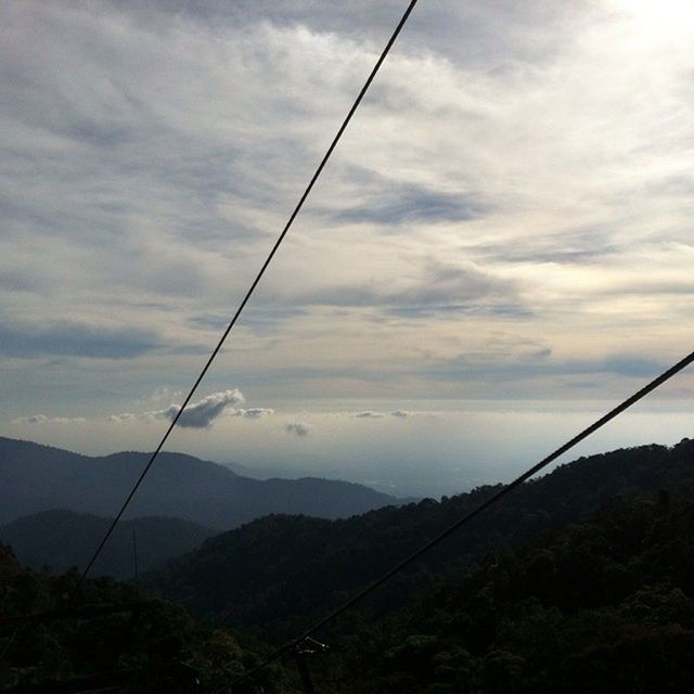 mountain, power line, sky, tranquility, tranquil scene, electricity pylon, mountain range, scenics, cable, electricity, beauty in nature, cloud - sky, landscape, nature, power supply, cloud, cloudy, connection, non-urban scene, fuel and power generation