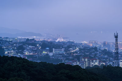 High angle view of illuminated buildings in city at night