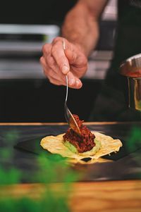 Close-up of man preparing food