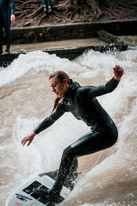 Side view of a man splashing water