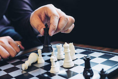 Midsection of man playing chess