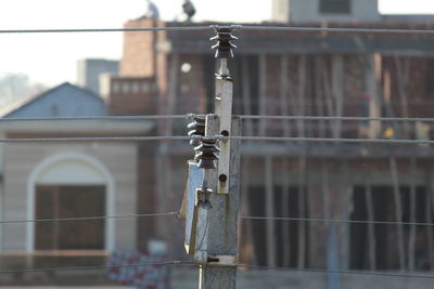 Close-up of metal fence against building