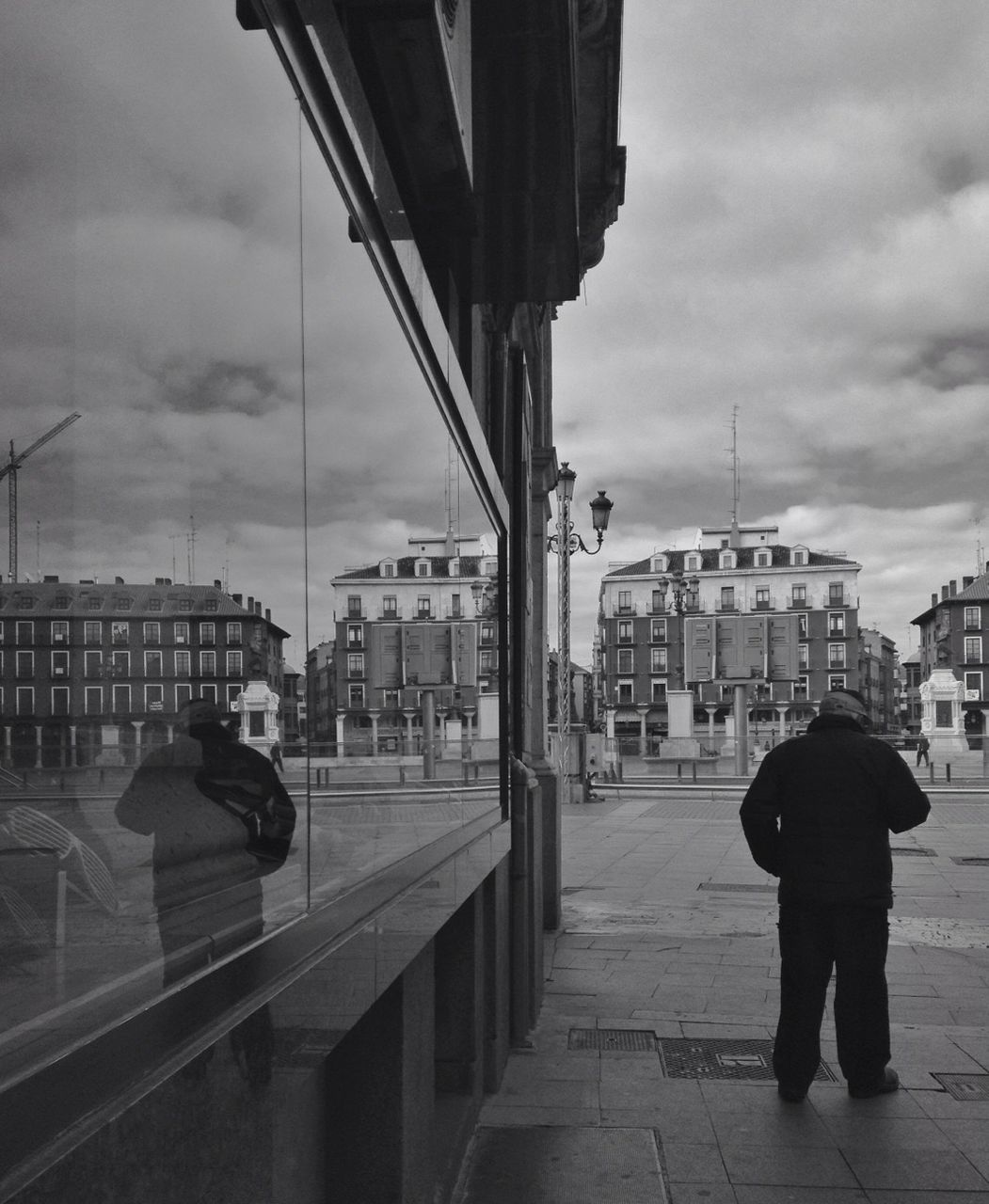 building exterior, architecture, sky, built structure, men, city, rear view, cloud - sky, lifestyles, person, walking, city life, full length, leisure activity, cloud, street, cloudy