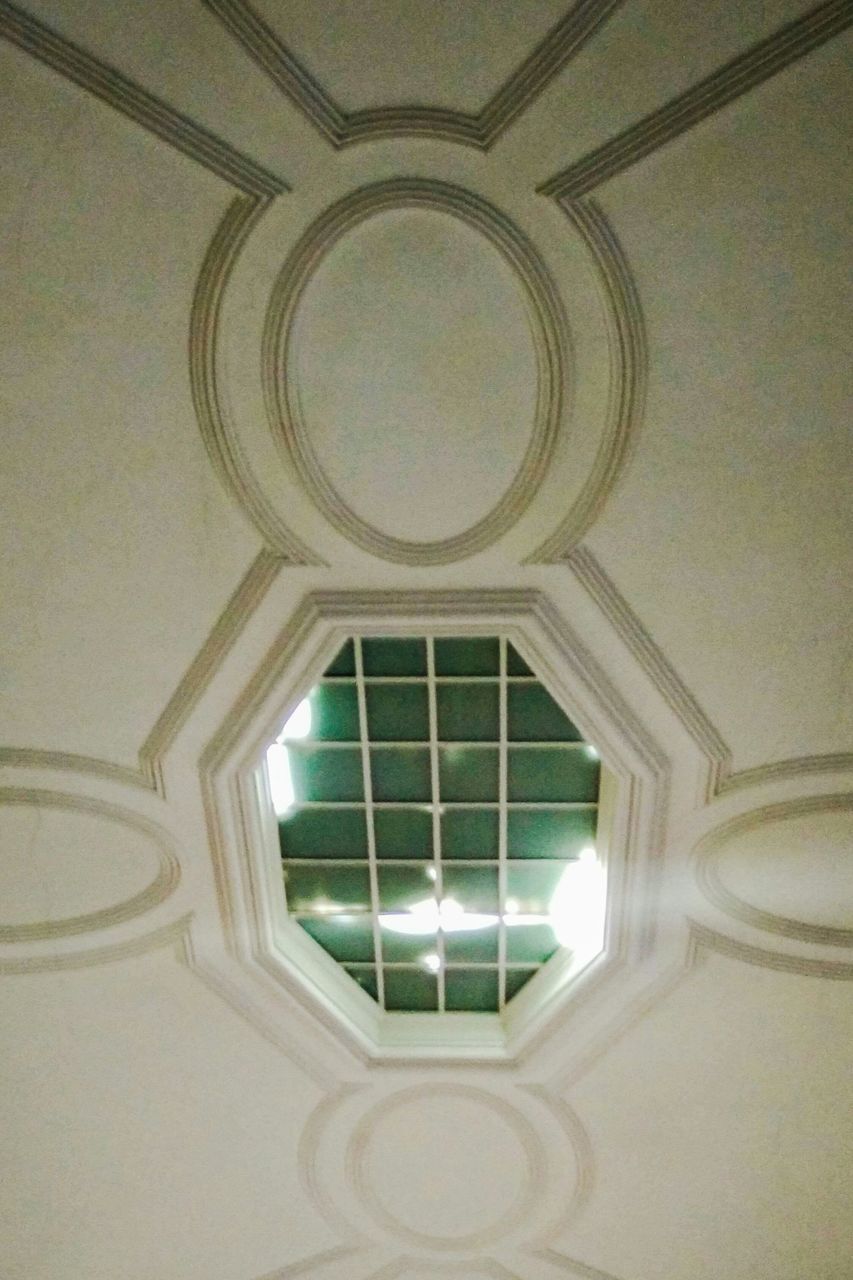 indoors, architecture, ceiling, built structure, low angle view, pattern, design, window, architectural feature, directly below, arch, geometric shape, ornate, glass - material, no people, shape, skylight, building, day, circle