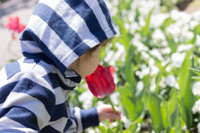 Baby smells flower.