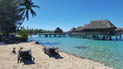 Stilt houses over sea against clear sky at hotel sofitel moorea ia ora beach resort