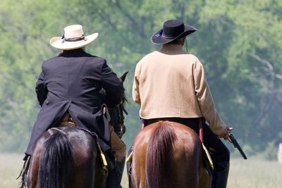 Rear view of man riding horse