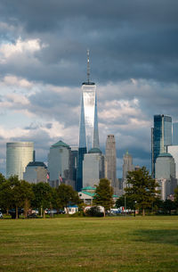 Buildings in city against cloudy sky