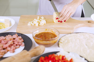 High angle view of woman preparing food on cutting board