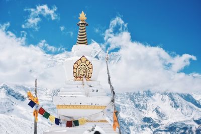 Temple against snowcapped mountains