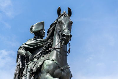 Low angle view of statue against blue sky