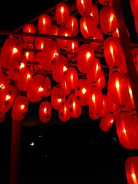 Low angle view of illuminated lanterns hanging at night