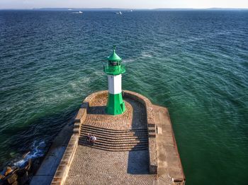 High angle view of lighthouse by sea