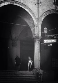 Full length of woman walking in tunnel