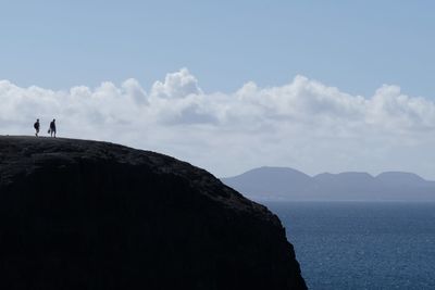 Scenic view of sea and mountains against sky