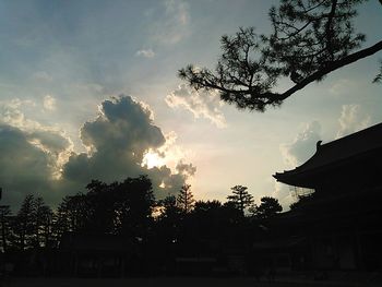 Low angle view of building against cloudy sky