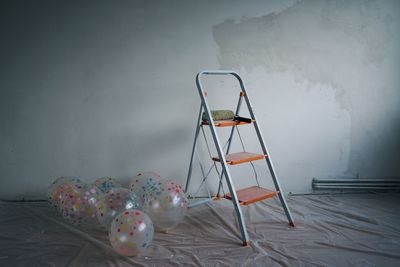 Balloons and ladder against wall during renovation at home