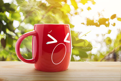 Close-up of red coffee cup on table