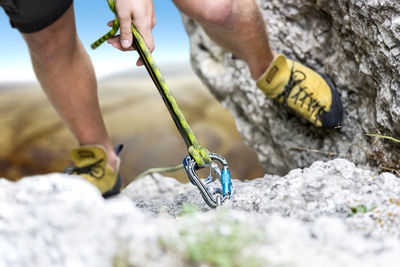 Low section of male climber climbing mountain