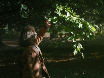 Rear view of man standing by tree