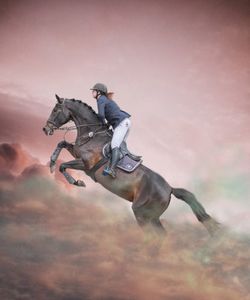 Man riding motorcycle against sky