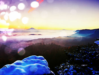 Scenic view of mountains against sky during sunset