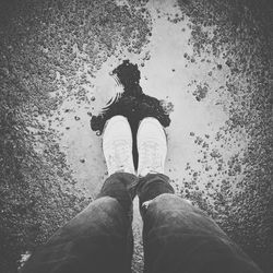 Low section of man standing on wet floor