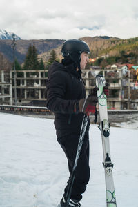 Rear view of man standing on snow