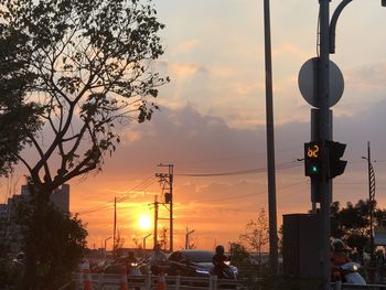 Traffic on road at sunset