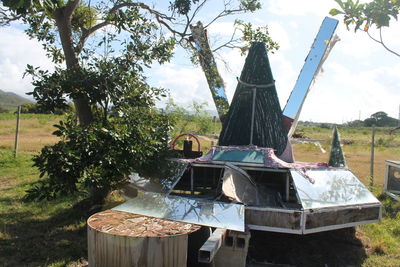 Traditional windmill on field against sky