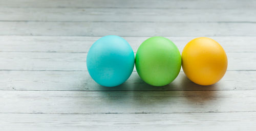 Close-up of multi colored eggs on wooden table