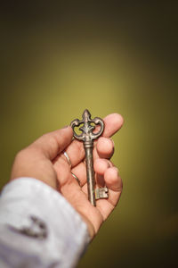 Cropped image of hand holding key
