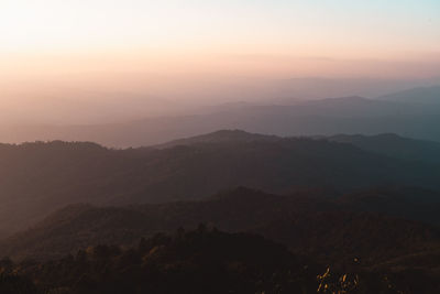 Scenic view of silhouette mountains against sky during sunset