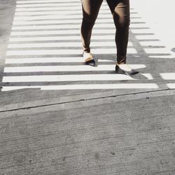 Low section of man standing on road