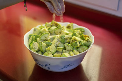 Close-up of hand holding salad