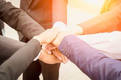 Midsection of couple holding hands