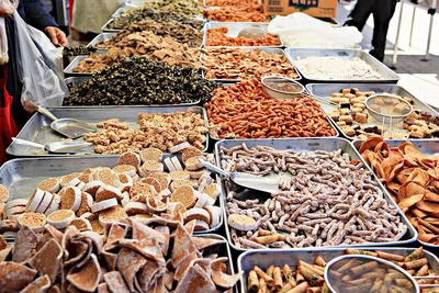 Man for sale at market stall