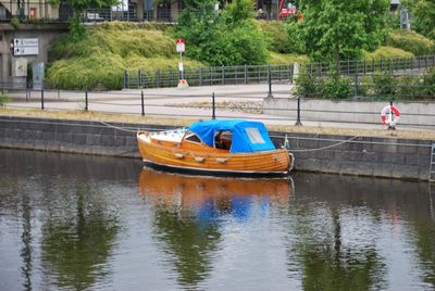 Boat moored on river in city