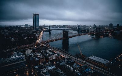 High angle view of bridge over river amidst buildings in city