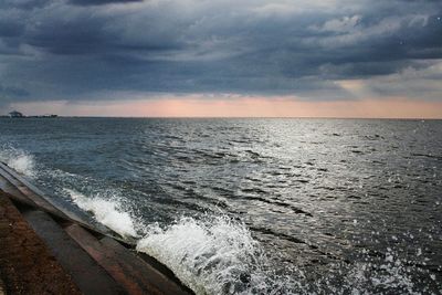 Scenic view of sea against cloudy sky