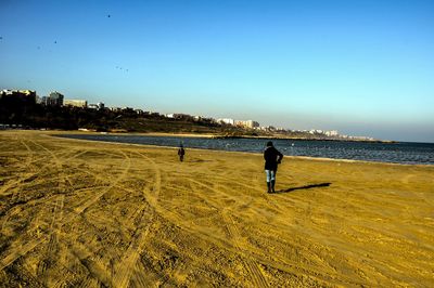 Scenic view of beach against blue sky