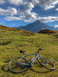 Bicycle on field against sky