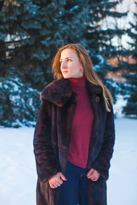 Young woman standing on snow