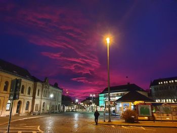 Illuminated buildings against sky at night