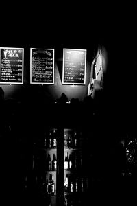 Reflection of man photographing in illuminated mirror