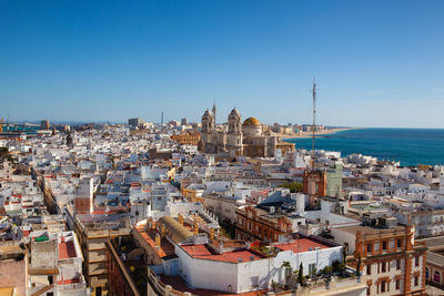 High angle view of cityscape against clear blue sky